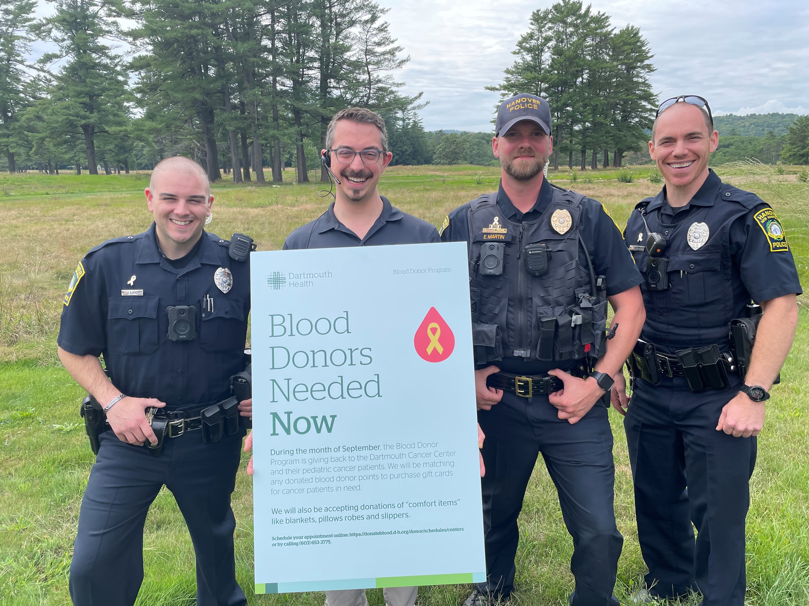 A picture of HPD members holding a blood donation sign.